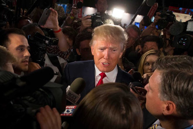 FILE- In this Aug. 6, 2015, file photo, Republican presidential candidate Donald Trump speaks to the media in the spin room after the first Republican presidential debate at the Quicken Loans Arena in Cleveland. Trump is showing no signs of curbing his battle with a Fox News television host, the Republican Party establishment and several presidential primary rivals who are accusing him of disrespecting women. (AP Photo/John Minchillo, File)