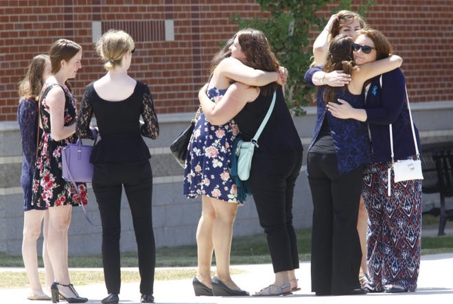 Friends comfort each other after a memorial service for teacher Emily Zarnoch at the Central Middle School in Quincy on Monday, Aug. 10, 2015. She was killed by a hit-and-run driver on Tuesday.