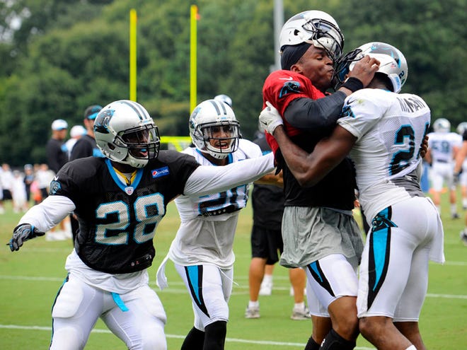 Carolina Panthers' Cam Newton (1) and Josh Norman (24) scuffle at the teams NFL football training camp at Wofford College in Spartanburg, S.C., Monday, Aug. 10, 2015.
