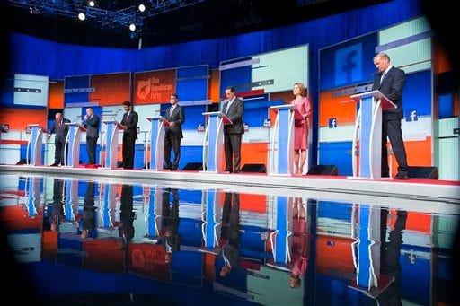 Republican presidential candidates from left, Jim Gilmore, Lindsey Graham, Bobby Jindal, Rick Perry, Rick Santorum, Carly Fiorina, and George Pataki participate in a pre-debate forum at the Quicken Loans Arena, Thursday, Aug. 6, 2015, in Cleveland. Seven of the candidates have not qualified for the primetime debate. (AP Photo/John Minchillo)