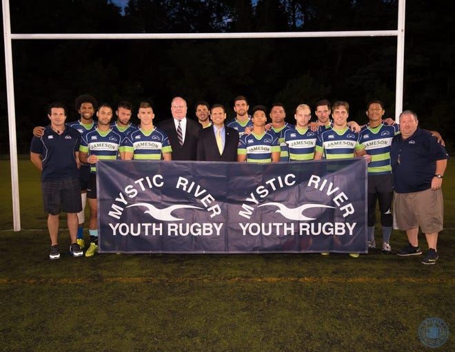 The Mystic River Rugby Club with (far left) Coach Kayne Bubb, Henry Kezer (sixth from the left), Mayor Gary Christenson (center) and Coach Joshua Smith (far right). Courtesy photo / Paul Hammersley, city of Malden