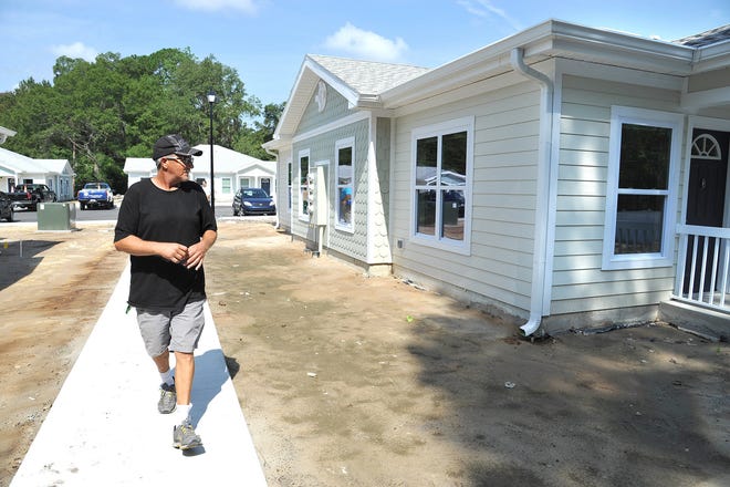 Key in hand, formerly homeless Paul Reichman approaches his new Westside apartment. He was one of the first to move into the latest complex developed by Ability of Housing of Northeast Florida, a nonprofit that provides affordable housing for the homeless.