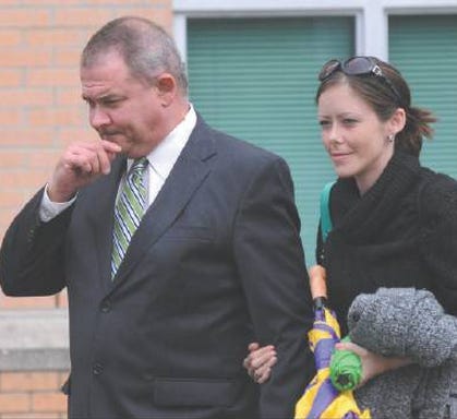 Former state Rep. Stephen LaRoque, left, and his stepdaughter leave the U.S. Courthouse in Greenville during his fraud trial in 2013. Federal authorities say he's yet to self-surrender to begin his prison term.