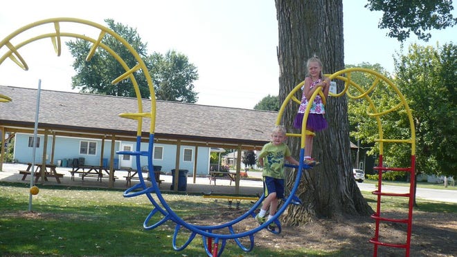 David and Victoria Browning, twins who are 7, Fyre Lake, Sherrard, enjoy the new camel climber at the park.