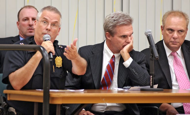 Worcester Police Capt. Roger Steele, left, addresses the crowd Thursday at the Worcester Senior Center. Listening are Phil Dowd, rear, of the Massachusetts State Police; Worcester District Attorney Joseph D. Early Jr.; and Worcester Mayor Joseph Petty. T&G Staff/Steve Lanava