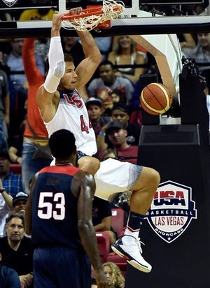 Blake Griffin dunks the ball against DeAndre Jordan (53) during a U.S. men's basketball intrasquad game, Thursday, Aug. 13, 2015, in Las Vegas. Sacramento Kings All-Star DeMarcus Cousins scored 24 points to lead the White team to a 134-128 victory over the Blue team. (AP Photo/David Becker)