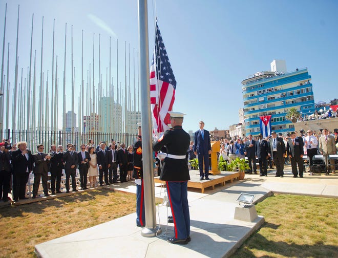 Secretary of State John Kerry and other dignitaries watch as U.S. Marines raise the U.S. flag over the newly reopened embassy in Havana, Cuba, Friday. Kerry traveled to the Cuban capital to raise the US flag and formally reopen the long-closed US Embassy. Cuba and the US officially restored diplomatic relations July 20, as part of efforts to normalize ties between the former Cold War foes.