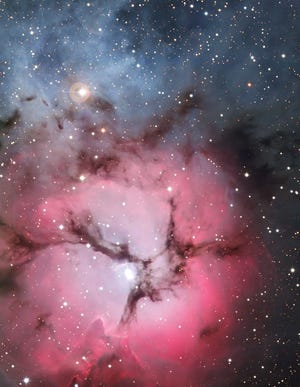 The Trifid Nebula, located in the constellation Sagittarius, is visible in a small telescope on summer evenings. A great deal of star formation occurs within this dust and gas filled expanse. It is also known as M20 or NGC 6514. ESO La Silla Observatory picture