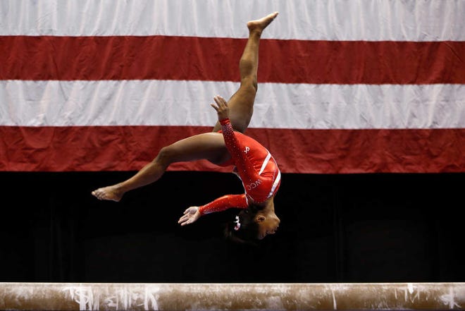 Simone Biles competes on the balance beam at the U.S. women's gymnastic championships Saturday, Aug. 15, 2015, in Indianapolis. Bliles won the balance beam portion of the competition. (AP Photo/AJ Mast)