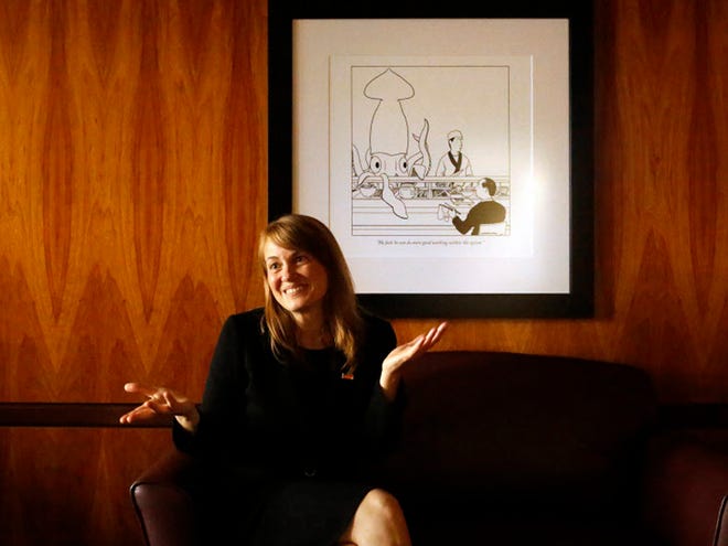 Laura Rosenbury, dean of UF's Levin College of Law, sits beneath a New Yorker cartoon that she finds apropos to her new job. An expert in feminist legal theory, she heads a department more closely associated with the state's entrenched legal establishment.