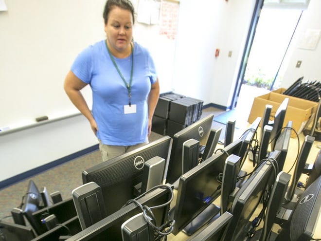 Desktop Support Technician Pam Griggs looks ever monitors to be installed as school system technology technicians replace 70 computers at Oakcrest elementary school in Ocala, Florida on Tuesday August 4, 2015. The update of the computers is part of a total of 2,700 old computers being replaced across 45 schools.