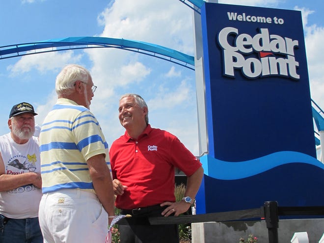 FILE - In this July 2, 2014, file photo, Matt Ouimet, chief executive of Cedar Fair Entertainment Co., greets a guest at Cedar Point amusement park, in Sandusky, Ohio. A man who entered a restricted area at the amusement park to look for a lost cellphone has been struck by a roller coaster and killed Thursday, Aug. 13, 2015.