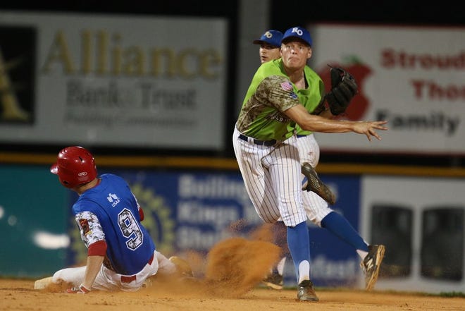 New Orleans, La., infielder Nicholas Ray fires the ball to first as Midland, Mich., runner Jordan Dopp (9) slides into second Sunday night at the ALWS. New Orleans grabbed a 2-1 win.