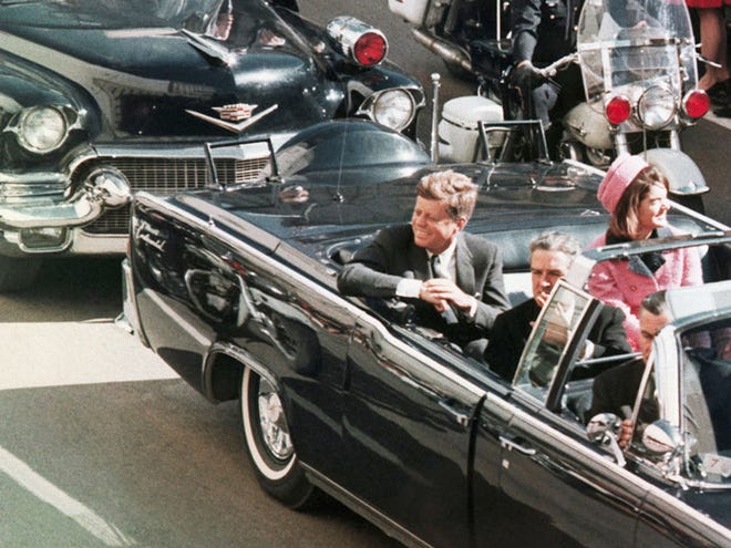 In this Nov. 22, 1963 file photo, President John F. Kennedy's motorcade travels through Dallas.