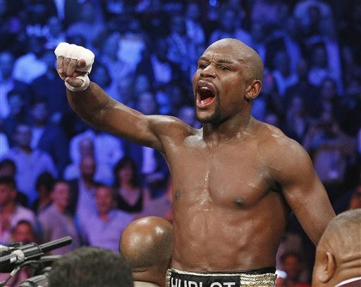 FILE - In this May 2, 2015, file photo, boxer Floyd Mayweather Jr., celebrates his unanimous decision victory over Manny Pacquiao, from the Philippines, after their welterweight title fight in Las Vegas. Plaintiffs who claim the May 2 Las Vegas fight between Manny Pacquiao and Mayweather Jr. was a fraud and they deserve their pay-per-view money back will argue their cases in front of a federal judge in Southern California. Judge R. Gary Klausner, the same judge hearing arguments in cases filed against the Sony movie studios related to that company"™s computer hacker attack last year, will decide if the Pacquiao cases are granted class action status before any trial proceeds. (AP Photo/John Locher, File)
