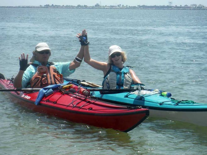 Provided by St. Johns River Alliance Gus Bianchi and Andrea Conover celebrate finishing their 310-mile kayak trip on the St. Johns River at Huguenot Park.