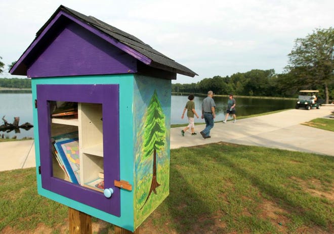 (Photo Mike Hensdill/The Gaston Gazette ) Gaston Eagle Scout hopeful Jesse Cook has built and installed 13 Little Free Libraries at parks and schools around Gaston County. Here, a Little Library at Rankin Lake Park seen Saturday morning, August 15, 2015.