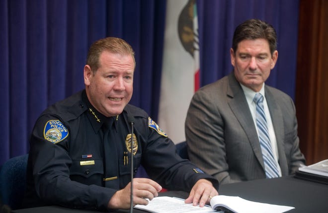 Stockton Police Chief Eric Jones, left, seated next to Rick Braziel of the Police Foundation, gives his reaction Monday to a report from the foundation about the department's handling of the July 16, 2014, Bank of the West robbery, in which a hostage and two robbers were killed. CLIFFORD OTO/THE RECORD