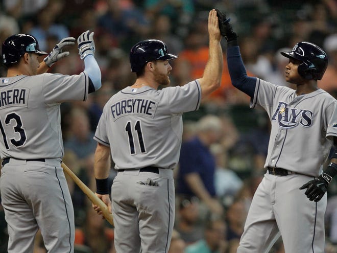 Tampa Bay Rays Tim Beckham, right, is congratulated by teammates Logan Forsyte, center, and Asdrubal Cabrera, left, after hitting a home run during the first inning of a baseball game, Monday, Aug. 17, 2015, in Houston.