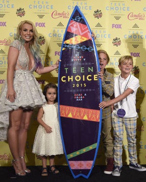 From left, Britney Spears, winner of the choice style icon award, poses with her niece Lexi and her sons Sean and Jayden James Sunday at the Teen Choice Awards at the Galen Center in Los Angeles. The Associated Press