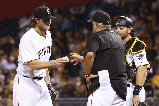 Pirates starting pitcher Gerrit Cole hands the ball to manager Clint Hurdle after being pulled in the sixth inning Monday against the Arizona Diamondbacks at PNC Park in Pittsburgh. Cole is 0-3 with a 4.70 ERA in four August starts.