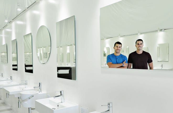 Will Shuhaibar, 30, CEO of TheBathOutlet, and his brother, Yaz Shuhaibar, 27, COO of the Upper Gwynedd company, pose in their new showroom.
