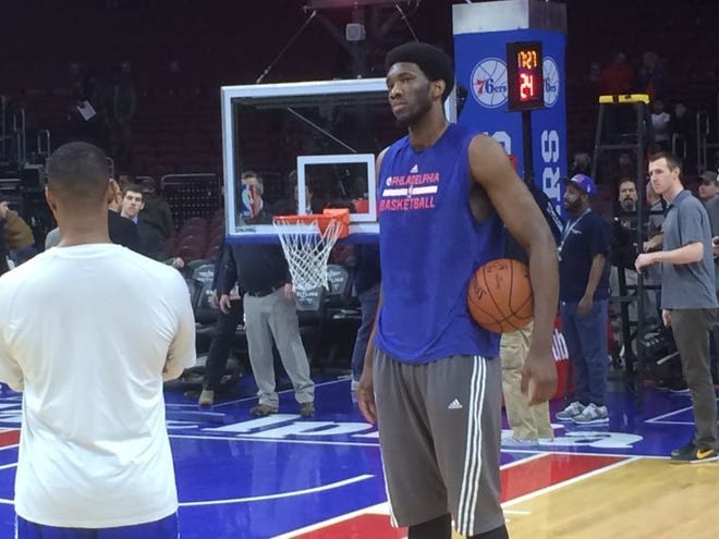 Injured Sixers center Joel Embiid takes a break during a pregame workout March 11, 2015 at the Wells Fargo Center.