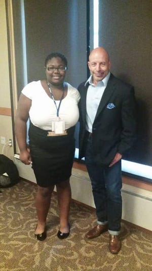 India Washington, left, interned at Johns Hopkins University Hospital this summer. She is 15 and a sophomore at Lenoir County Early College High School. With her is James Giordano, adjunct professor, director, neuroethics studies, and lecturer at Georgetown University.