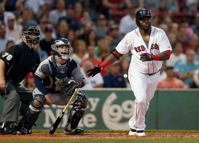 Boston Red Sox's David Ortiz watches his RBI double in front of Cleveland Indians' Roberto Perez during the first inning of a baseball game in Boston, Tuesday, Aug. 18, 2015.