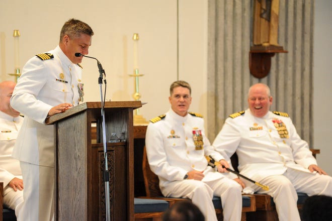 Capt. John Spencer, commodore of Submarine Squadron Sixteen, reads a letter from Capt. William Breitfelder's son while Capt. David Adams laughs at the punch line, "Go Army, Beat Navy."