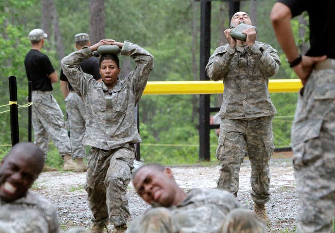 In this photo taken on April 19, 2015, one of the 20 female soldiers, top left, who is among the 400 students who qualified to begin Ranger School, does lunges in between obstacles on the Darby Queen, one of the toughest obstacle courses in U.S. Army training, at Fort Benning, Ga. Two women have passed the Army's grueling Ranger test, but tougher and more dangerous jobs could lie ahead, senior officials told The Associated Press. The military services are poised to allow women to serve in most front-line combat jobs, including as special operations forces. (Robin Trimarchi/Ledger-Enquirer via AP) MANDATORY CREDIT