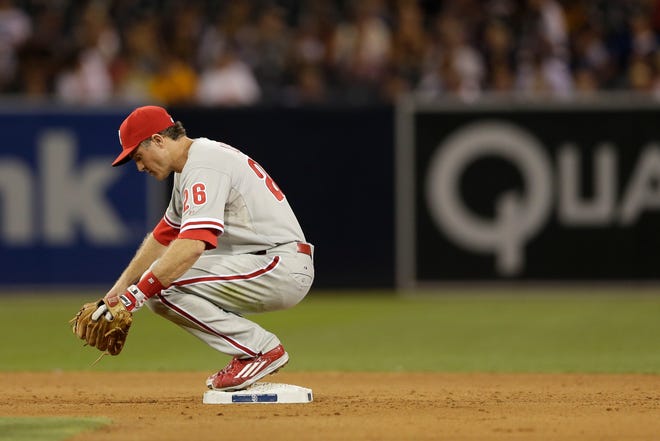 In this file photo, Philadelphia Phillies second baseman Chase Utley rests on second base while playing the San Diego Padres in a baseball game Friday, Aug. 7, 2015, in San Diego.