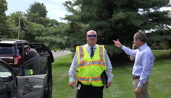 State Rep. Steve Santarsiero tours his legislative district with PennDOT officials to show them where local road work needs to be done. Here he points out the traffic lights at Stoopville Road to PennDOT's Jim Krafczk. Santarsiero wants full working lights instead of the current blinkers.