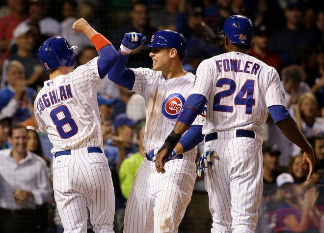 Chicago Cubs' Anthony Rizzo, center, celebrates with Chris Coghlan, left, and Dexter Fowler after hitting a three-run home run during the third inning of a baseball game against the Atlanta Braves, Thursday, Aug. 20, 2015, in Chicago.