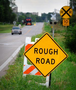 A sign on East Country Club Road alerts drivers to road conditions.