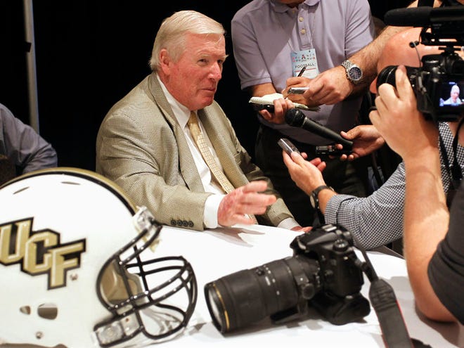 In this Aug. 4, 2015, file photo, Central Florida coach George O'Leary, left, speaks with reporters at the American Athletic Conference NCAA college football media days in Newport, R.I. UCF has been the darling of the American Athletic Conference the past two seasons, claiming back-to-back titles. Despite losing 14 starters from last season, the Knights should be in the mix for a third.
