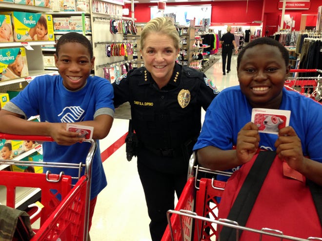 Jamarion Summers, Sarasota Police Chief Bernadette DiPino and Jarvis Hodo shop for back-to-school supplies Thursday at Target. An anonymous donor gave $100 gift cards to roughly 20 children from the Boys and Girls Club of Sarasota County. Photo provided by the Sarasota Police Department