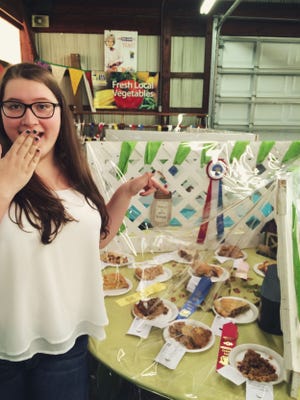 Kim shows off her winning apple pie alongside the other dessert entries at the Middletown Grange Fair.