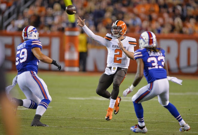 Cleveland Browns quarterback Johnny Manziel (2) throws under pressure from Buffalo Bills' A.J. Tarpley (59) and Ron Brooks (33) during the third quarter of an NFL preseason football game, Thursday, Aug. 20, 2015, in Cleveland. (AP Photo/David Richard)