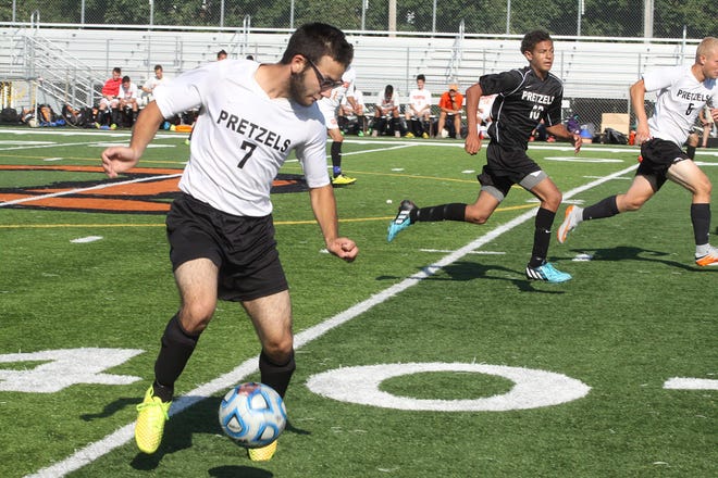 Kurt Rodriguez (left) kicks the ball during a varsity soccer scrimmage at Pretzel Stadium on Friday, Aug. 21, 2015, at Freeport High School. The annual Pretzel Sports Kickoff is sponsored by the Pretzel Fans Club as a fundraiser for all Freeport High School sports. JANE LETHLEAN/THE JOURNAL-STANDARD