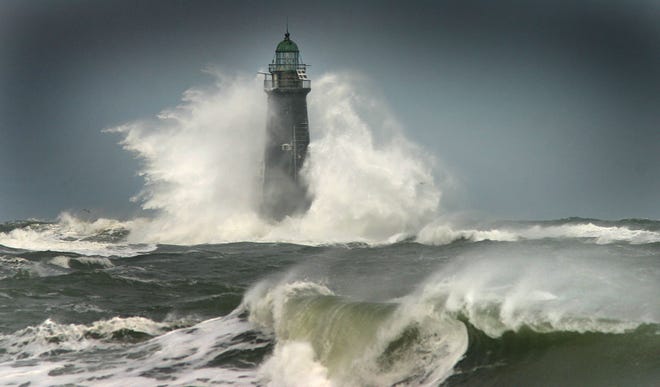 Minot Light off the coast of Cohasset and Scituate takes the brunt of heavy waves from a storm.