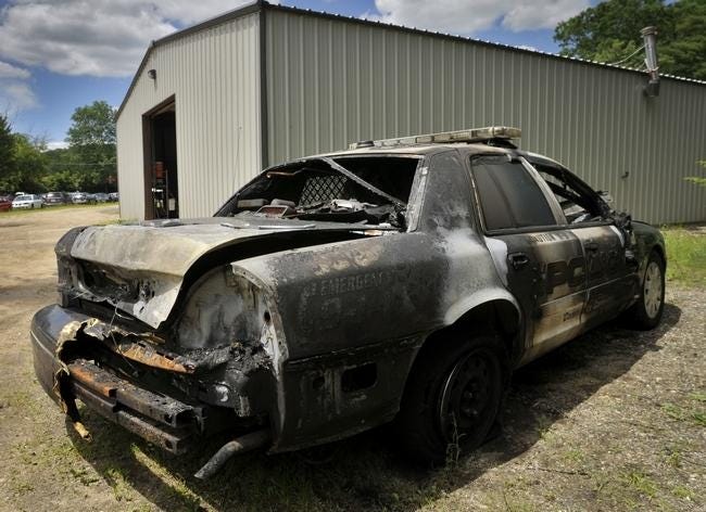 The burned-out police cruiser, photographed at Dave's Auto Service in Southbridge on June 17. T&G Staff/Paul Kapteyn