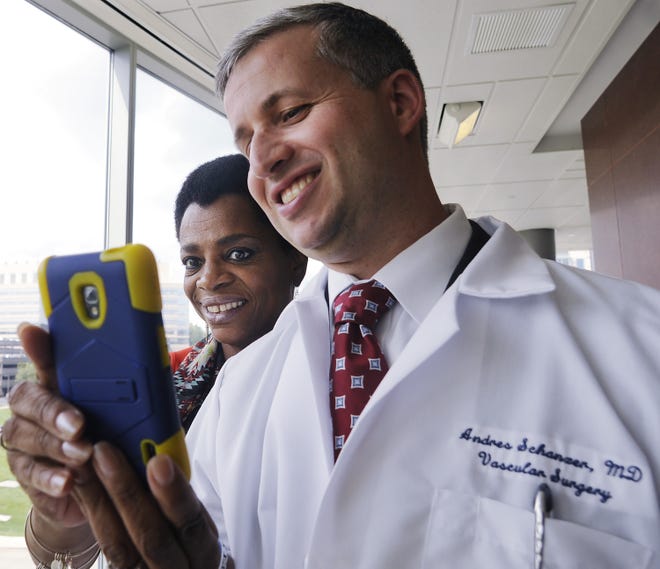 Wanda Boone of Springfield takes a selfie with Dr. Andres Schanzer. Her Aortic repair was done at Umass Center for Complex Aortic Disease. T&G Staff/CHRISTINE PETERSON