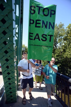 A group of concerned citizens lead the protesters as they march across the Milford Bridge to show their opposition to the proposed PennEast pipeline Saturday August 22, 2015 in Upper Black Eddy, Pennsylvania. (Photo by William Thomas Cain)