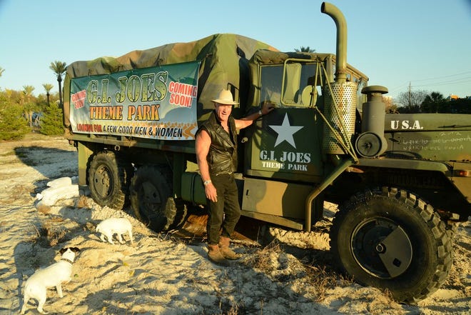 Joe Bruner shown here beside his military-themed amusement park teasers last fall.