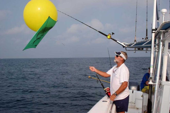 Bob McNally For the Times-Union Capt. George Mitchell deploys a helium-inflated balloon with fishing kite attached for king mackerel trolling. This live bait tactic is rarely used in local waters, but is a go-to fishing technique in many regions.