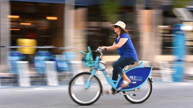 Barbara Marshall scoots down Clematis Street on a rented SkyBike. Jeffrey Langlois / Palm Beach Daily News