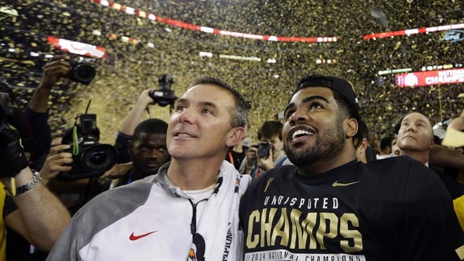 Ohio State coach Urban Meyer (left) and Buckeye standout Ezekiel Elliott celebrate their win over Oregon in last year’s NCAA college football playoff championship game. The Buckeyes return a lot of talent and are being picked by many to repeat as national champions. (AP Photo/David J. Phillip, File)