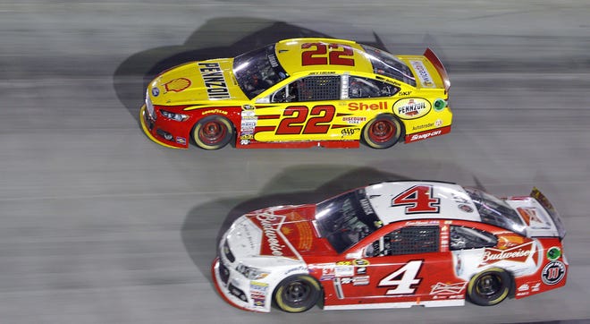 Joey Logano (22) and Kevin Harvick (4) go into a turn during the NASCAR Sprint Cup Series auto race, Saturday, Aug. 22, 2015, in Bristol, Tenn. Logano won the race and Harvick was second.