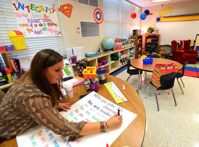 Photos by Bob.Mack@jacksonville.com Second grade teacher Alycia Campbell works on a chart for her room after finishing most of her preparations at GRASP Academy. Duval County's only new school will open Monday in the former Justina Road Elementary with about 225 students